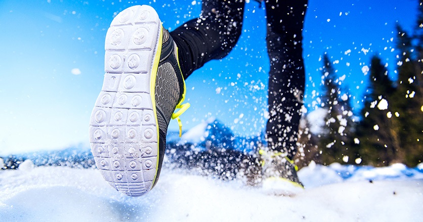Legs of a young runner outside in winter nature